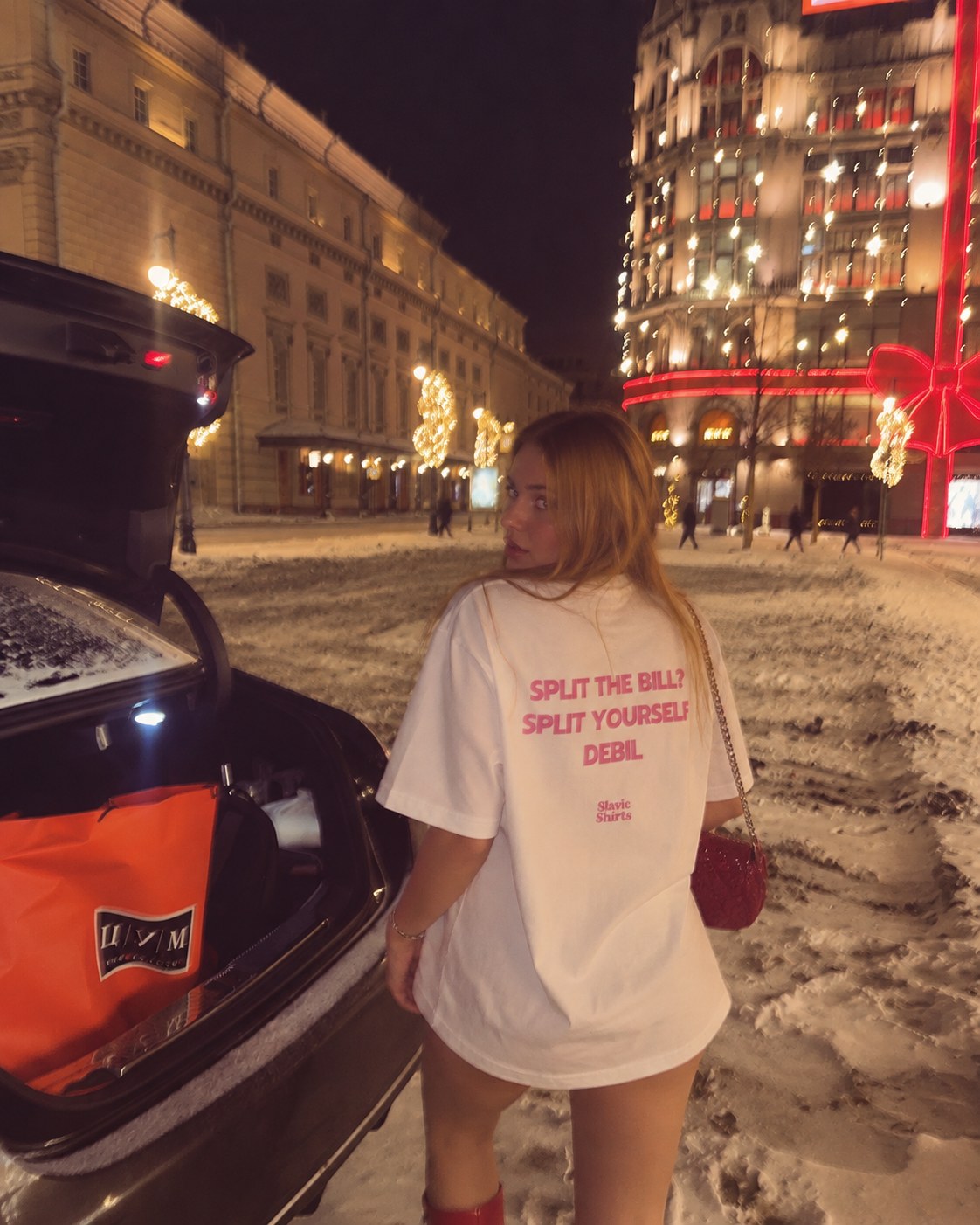 Wearing the Split The Bill? Split Yourself Debil tee on a snowy city street at night